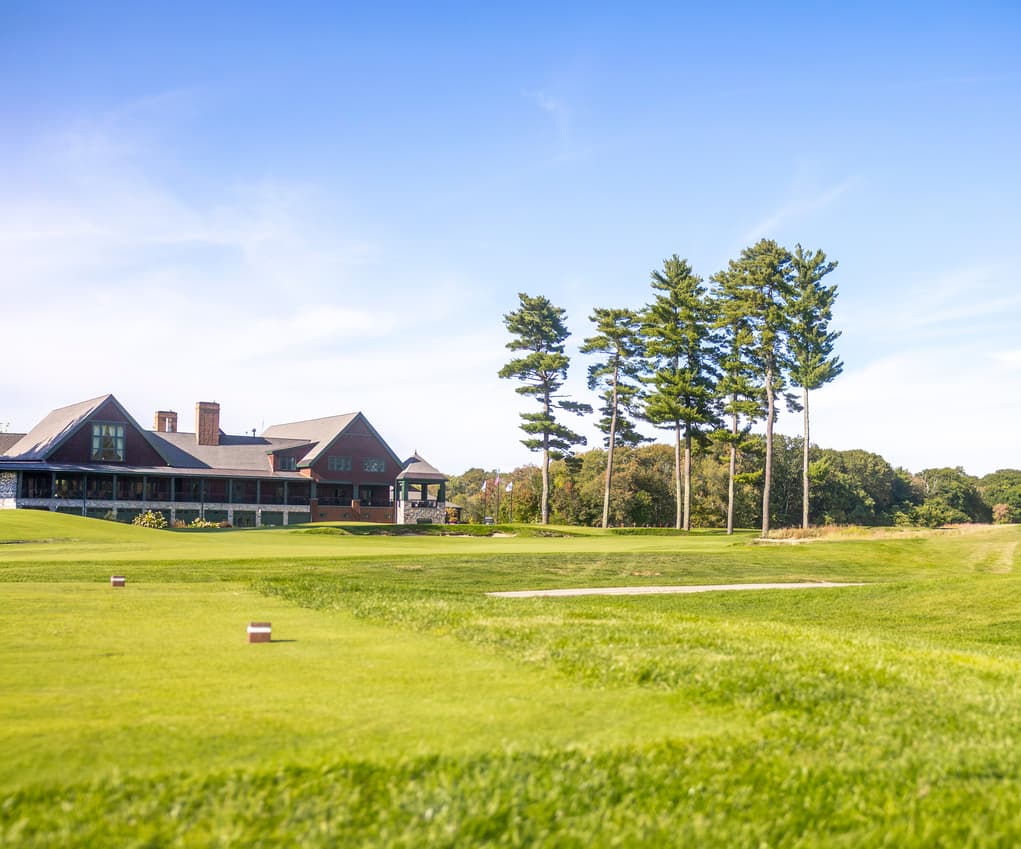 A clubhouse and grounds of a golf course
