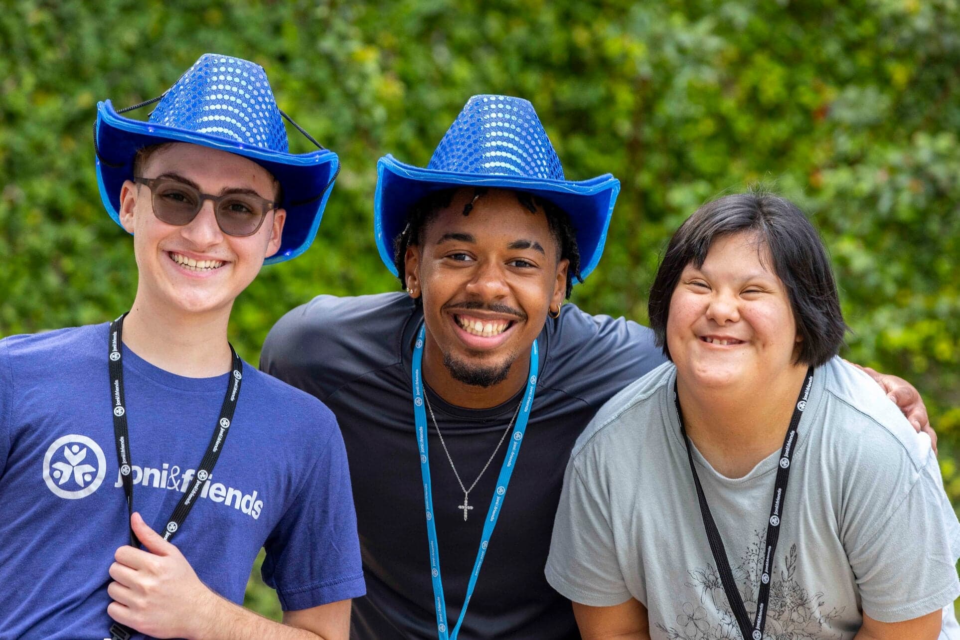 Threee people all smiling for the camera. 