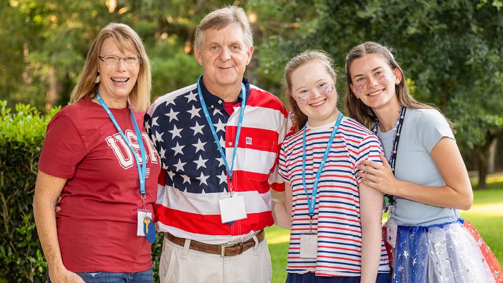 Four people smiling and posing for the camera.