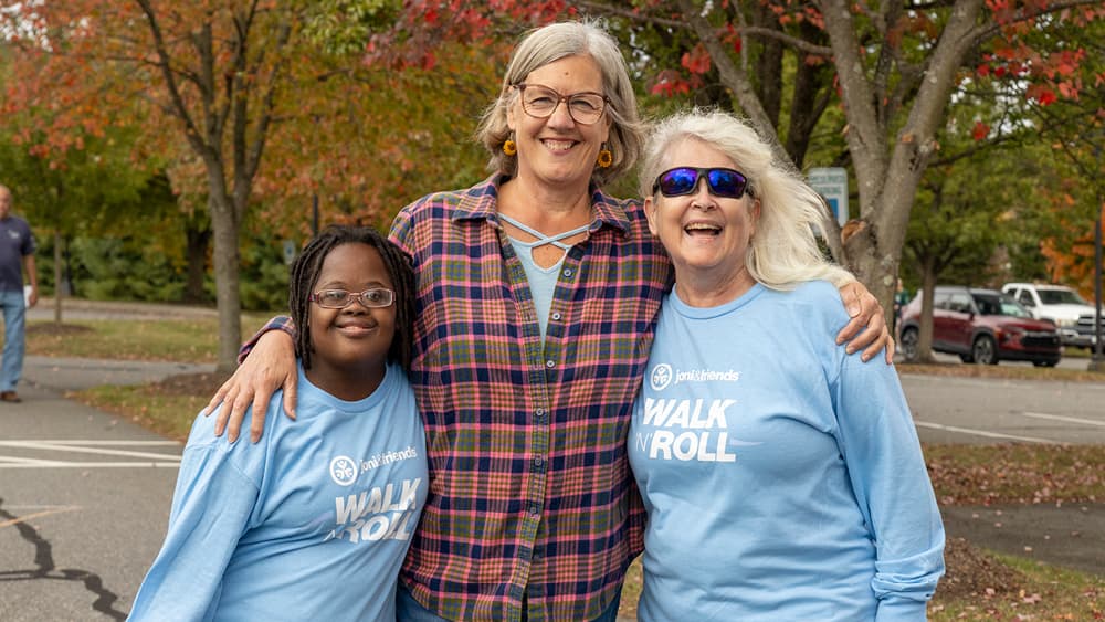 Three women smiling and posing for the camera.